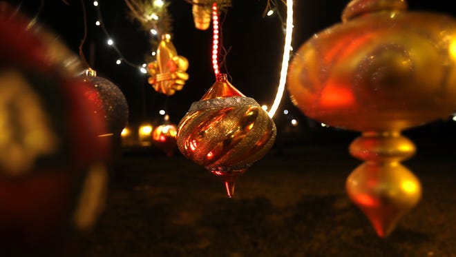Ornaments hang on a tree at Minium Park in Aztec. The City of Aztec kicks off its annual Aztec Sparkles Lighting Contest on Dec. 1.