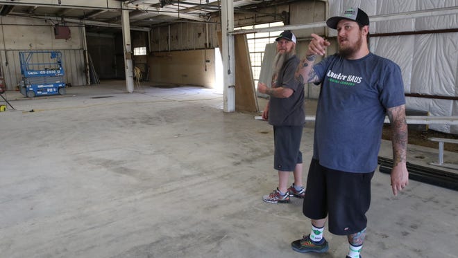 Owner and brew master Brandon Beard points out the location of the offices and restrooms at the Lauter Haus Brewing Company in Farmington on Friday.