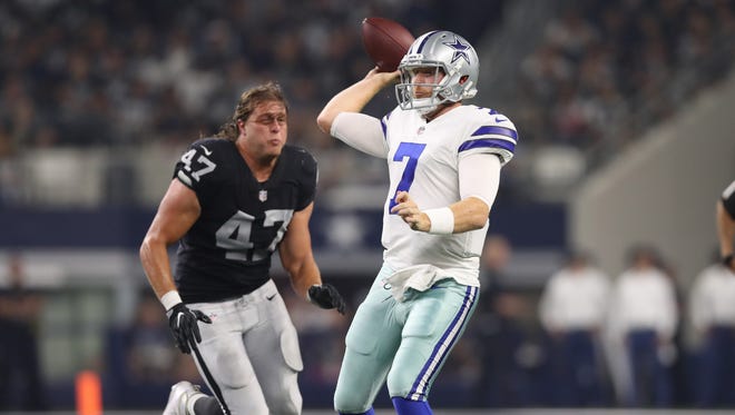 Dallas Cowboys quarterback Cooper Rush (7) throws under pressure from Oakland Raiders defensive end James Cowser (47) who lost his helmet on the play at AT&T Stadium.