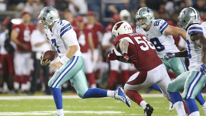 Dallas Cowboys quarterback Cooper Rush (7) scrambles with the ball against the Arizona Cardinals during the fourth quarter at Tom Benson Hall of Fame Stadium.