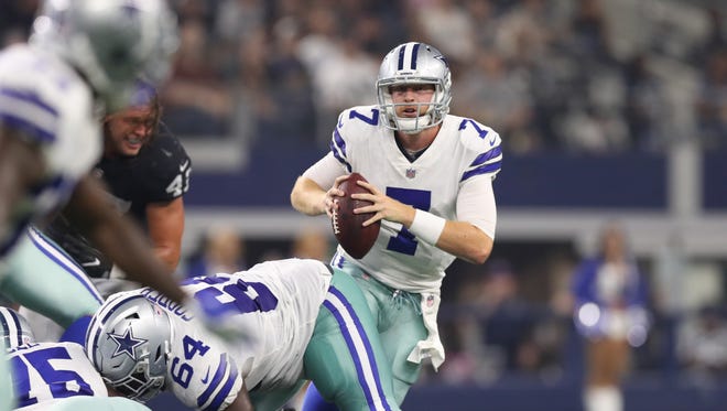 Dallas Cowboys quarterback Cooper Rush (7) scrambles against the Oakland Raiders at AT&T Stadium.