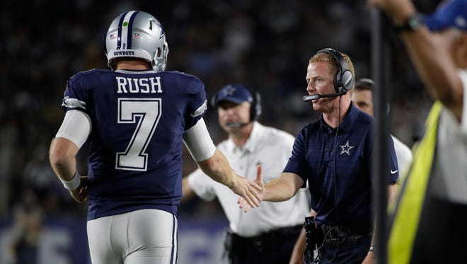 Dallas Cowboys quarterback Cooper Rush (7) shakes hands with head coach Jason Garrett during the second half of a preseason NFL football game against the Los Angeles Rams Saturday, Aug. 12, 2017, in Los Angeles.
