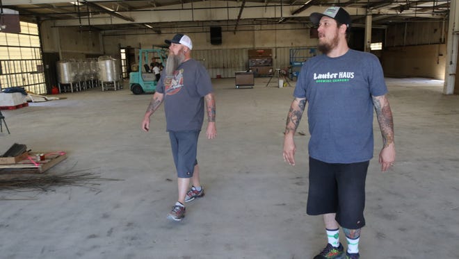 Owner and brew master Brandon Beard, right, expects construction at the Lauter Haus Brewing Company to be completed by July.