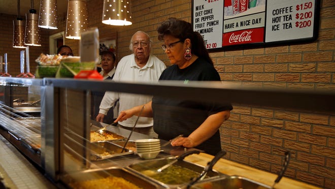 Bernie Sandoval, owner and manager of Chef Bernie's Restaurant, and Drusilla Begay prepare food in the buffet line at Chef Bernie’s Restaurant.