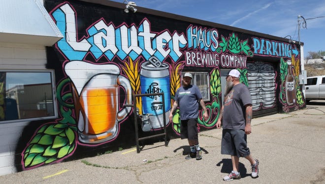 Owner and master brewer Brandon Beard, left, and business partner Brad Foley walk the parking lot at Lauter Haus Brewing at 1806 E. 20th St. in Farmington on Friday.