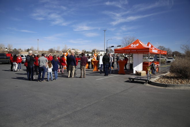 Community members gather at the site of a planned Whataburger restaurant on East Main Street in Farmington on Tuesday, March 12 for a press conference during which details about the business were presented.