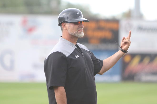 Farmington Frackers coach Mike McGaha gives a signal to the batter's box against the Colorado Cutthroats during Friday's game at Ricketts Park in Farmington.