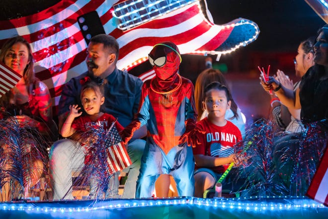 Participants on the Zia Natural Gas float ride down the street at the annual Las Cruces Electric Light Parade on Wednesday, June 3, 2019.