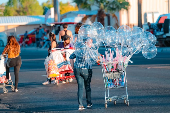Venders sell goods at the annual Las Cruces Electric Light Parade near Apodaca Park on Wednesday, June 3, 2019.