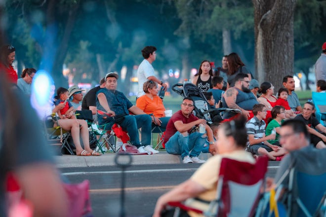 Spectators wait for the annual Las Cruces Electric Light Parade to start near Apodaca Park on Wednesday, June 3, 2019.
