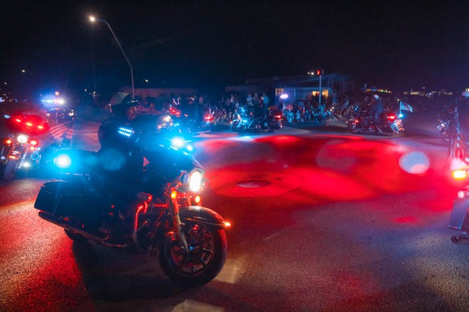 Police ride up and down the street at the annual Las Cruces Electric Light Parade near Apodaca Park on Wednesday, June 3, 2019.