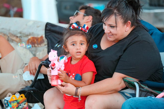 Tina Moreno and her granddaughter Aalyah Angel wait for the annual Las Cruces Electric Light Parade to start near Apodaca Park on Wednesday, June 3, 2019.