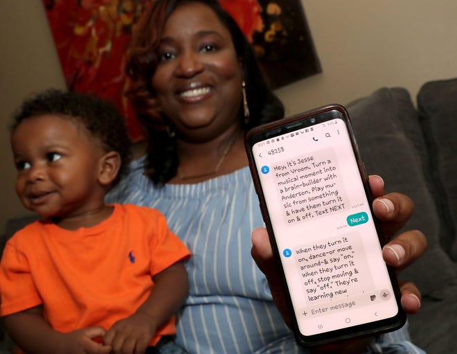 Tonia Tucker shows a message she received through Vroom while sitting with her 15-month old son, Anderson Dye, at Tucker’s home in Milwaukee on Wednesday, Aug. 21, 2019. Vroom, which has a website and an app, helps parents of young children turn everyday experiences into learning activities.