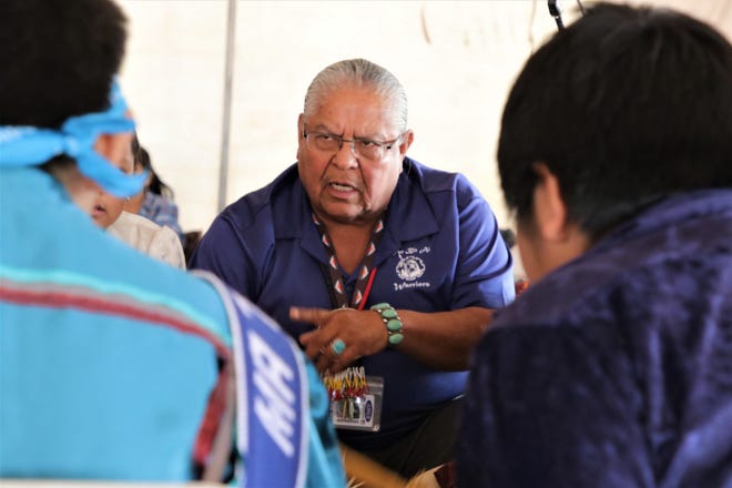 Tsé Bit’a’I Middle School heritage language teacher Elvin Keeswood leads a student drum circle, Thursday, Oct. 3, 2019, during the 108th Northern Navajo Nation Fair in Shiprock.