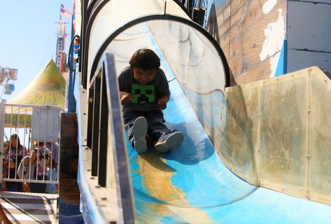 Kendrick King slides on a carnival raid at the 108th Northern Navajo Nation Fair on Oct. 3 in Shiprock.