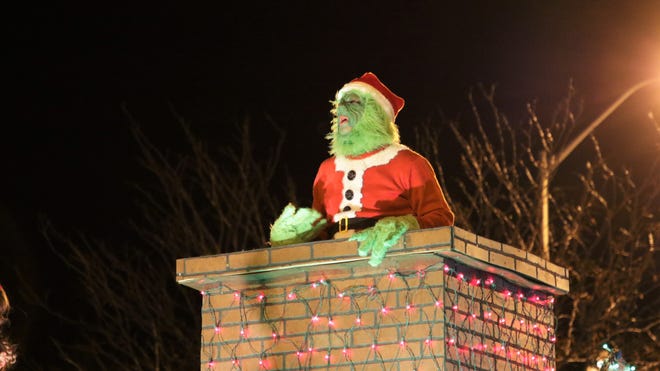 Dr. Seuss ' The Grinch was seen singing out of a chimney at Farmington ' s annual Christmas Parade in Farmington on Dec. 5, 2019.