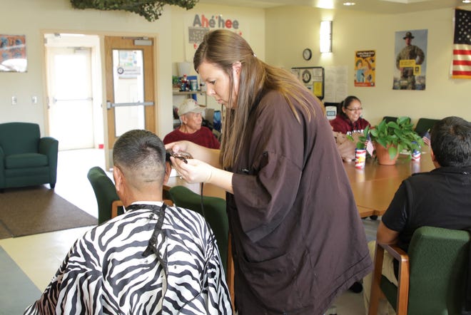 Veterans received free haircuts from AmeriCorps member Jennifer Arthur, center, as part of a service provided by the program at the San Juan Chapter house in Lower Fruitland.