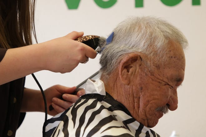 Army veteran Fred Eaton Sr. receives a free haircut on Dec. 6, 2019, at the San Juan Chapter house in Lower Fruitland. The service is part of the AmeriCorps program at the chapter.