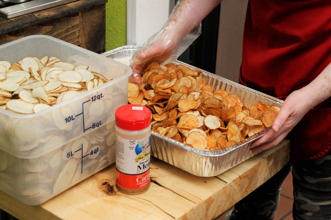 Freshly made potato chips are being prepared to be served at Mama's Deli in downtown Farmington on Dec. 16, 2019.