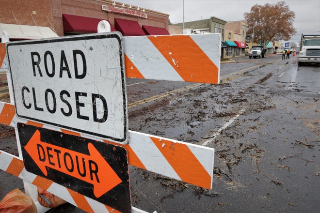A street closure sign and debris from a cut-down tree are pictured on West Main Street in downtown Farmington on Dec. 27, 2019, as city crews prepare the district for the Complete Streets renovation beginning early next month.