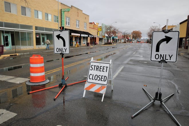 Signs direct West Main Street motorists to turn left or right on to Behrend Avenue in downtown Farmington on Dec. 27, 2019, as preparations for the beginning of the Complete Streets project got underway.