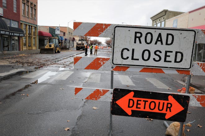 City workers confer in the middle of West Main Street on Dec. 27, 2019, as preparations for the Complete Streets construction got underway.