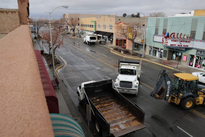 City trucks wait to haul away debris from downed trees on West Main Street on Dec. 27, 2019.