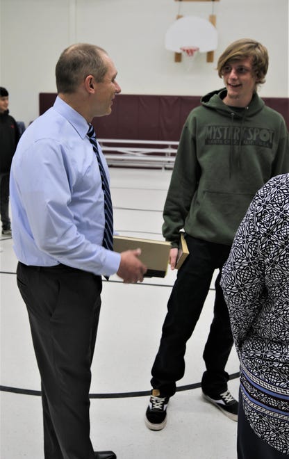 Teacher Seth Levine and Rocinante High School graduate Sean Jobe converse while waiting to have their copies of "The Broken Circle" signed by author Rodney Barker on Jan. 10, 2020, in Farmington.