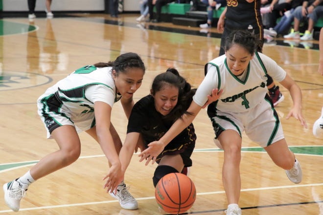 Farmington's Carolyn Thomas (10), Tohatchi's Cameron Tsosie and Farmington's Audrey Henderson (4) chase after the loose ball during Saturday's girls basketball game at Scorpion Arena in Farmington.