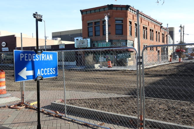 A cyclone fence encircles a three-block stretch of Main Street through downtown Farmington, including this section in front of the Three Rivers Brewing block, as work on the Complete Streets project continues.