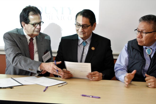 San Juan County Commission Chairman Jack Fortner, Navajo Nation President Jonathan Nez and Vice President Myron Lizer participate in a signing ceremony for a memorandum of understanding, Thursday, Feb. 20, 2020, at San Juan College's School of Energy.