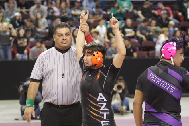 Aztec's Princess Altisi celebrates defeating Miyamura's Nancy Rodriguez for the Girls 160-pound division title in Saturday's New Mexico State Wrestling Championships at the Santa Ana Star Center in Rio Rancho.