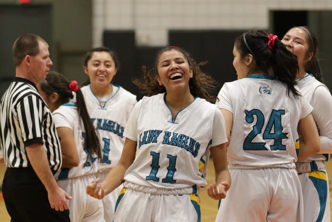 Navajo Prep's Hailey Martin is all smiles after making an and-one 3-pointer against Crownpoint during Wednesday's District 1-3A girls basketball tournament semifinals game at the Eagles Nest in Farmington.