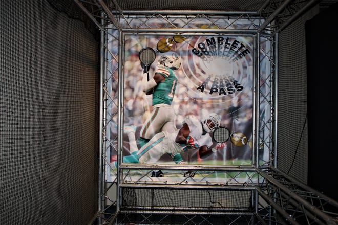A display included in the "Gridiron Glory" exhibition allows visitors the chance to test their passing accuracy.