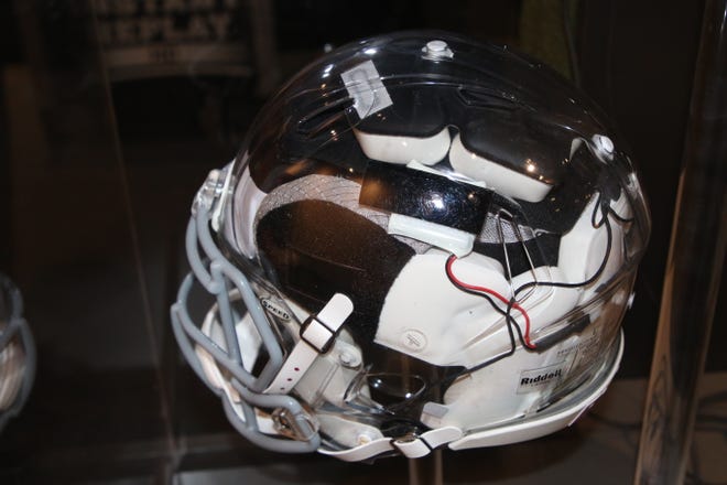 A see-through helmet wired with a radio transmitter for receiving play calls is featured in the "Gridiron Glory" exhibition at the Farmington Museum at Gateway Park.
