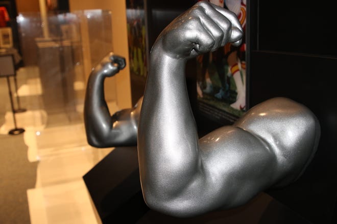 A display that allows visitors the chance to compare the size of their biceps and forearms to those of NFL players is included in the "Gridiron Glory" exhibition.