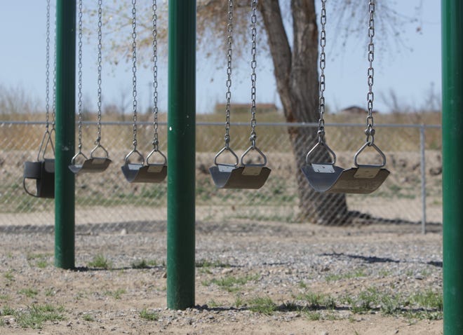 Empty swings are pictured on April 25 at Nizhoni Park in Shiprock. Residents on the Navajo Nation are under a weekend curfew to combat the spread of the coronavirus.