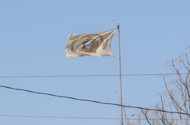 A flag of the Navajo Nation moves in the wind on April 25 near Shiprock. The tribe is under a weekend curfew to help combat the spread of the coronavirus.