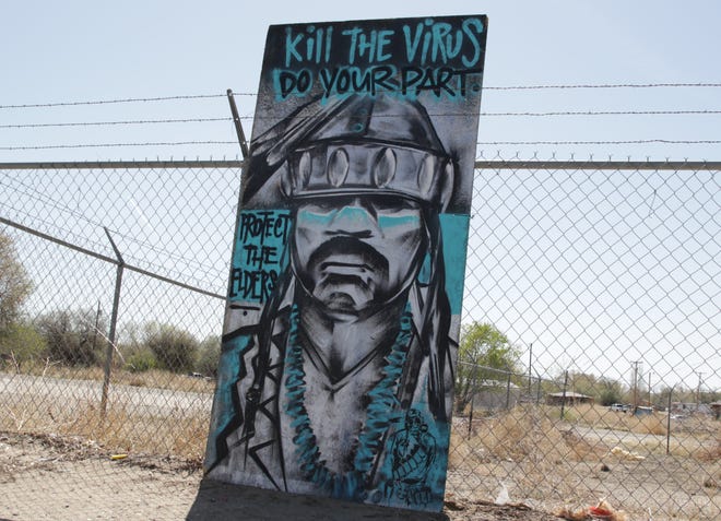 A piece of artwork reminds community members to stay at home on April 25 in Shiprock. The Navajo Nation is under a weekend curfew to combat the spread of the coronavirus.