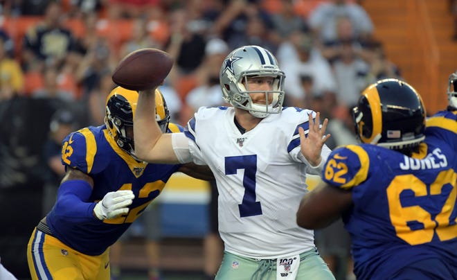Aug 17, 2019;  Honolulu, HI, USA; Dallas Cowboys quarterback Cooper Rush (7) throws the ball under pressure from Los Angeles Rams linebacker Josh Carraway (42) and defensive tackle Bryant Jones (62) at Aloha Stadium.The Cowboys defeated the Rams 14-10.