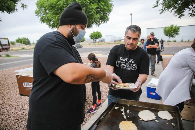 Israel Baca, left and Jesse Ramos, cook bacon and pancakes to feed residents of the Mesilla Valley Community of Hope on Sunday, May 10, 2020.