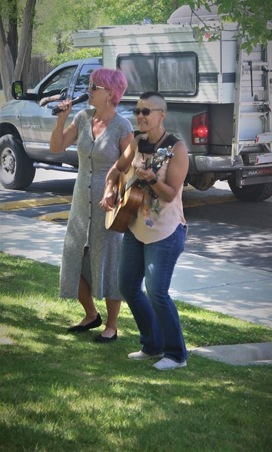Cecilia Taulbee-Leaming and Monica Leaming of the Zia Chicks entertain residents of The Bridge at Farmington assisted living center on May 13, 2020, during the Parking Lot Love Parade.