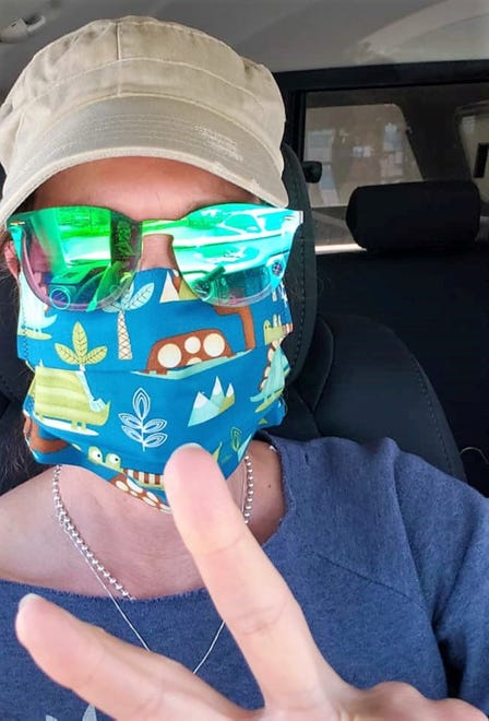 Pamela Witte shows off her mask made by "Project Facemask." Designs vary and are colorful. The project began production in the wake of COVID-19 when a need for PPEs became more apparent since April, 2020.