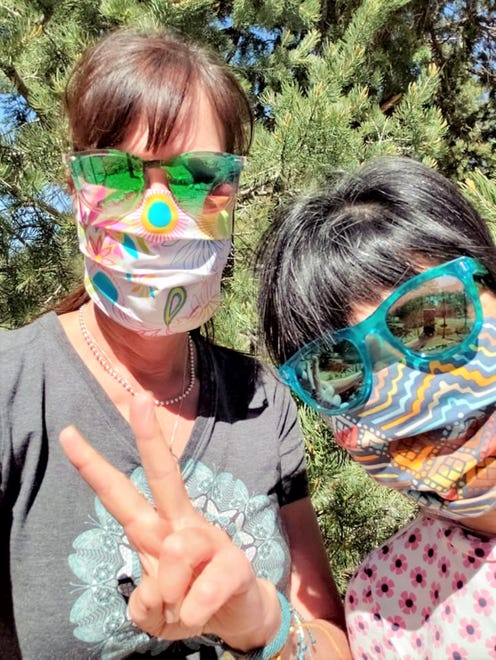 Pamela Witte and Aya Bates show off their colorful masks that were made by Project Facemask. They have made hundreds of masks since the pandemic began in March 2020.