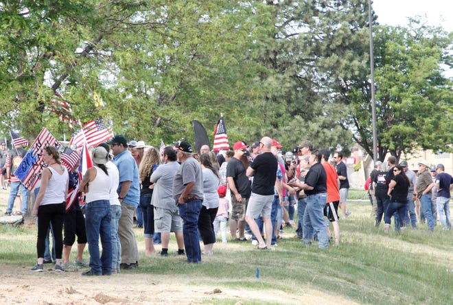 A crowd gathers to protest business restrictions amid the coronavirus pandemic, Thursday, May 14, 2020, in Farmington.