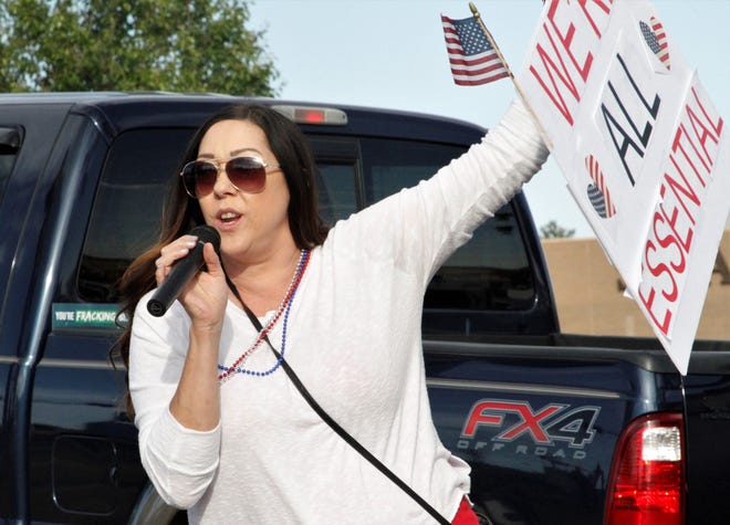 Shannon Carter speaks, Thursday, May 14, 2020, during a protest against the public health orders that closed businesses.