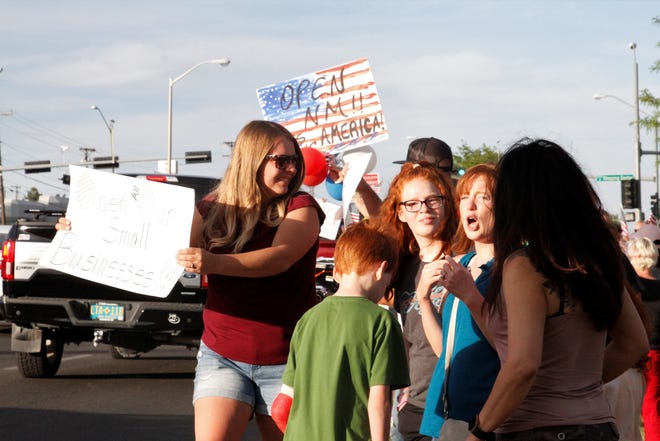 Protesters demand businesses be allowed to reopen, Thursday, May 14, 2020, in Farmington.