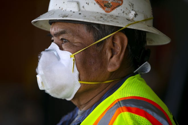 Dennison Bia, with the Navajo Nation Facilities Maintenance Department, looks on as they wait for aid supplies to be trucked to the Window Rock Airport in Window Rock on the Navajo Nation  on May 15, 2020.