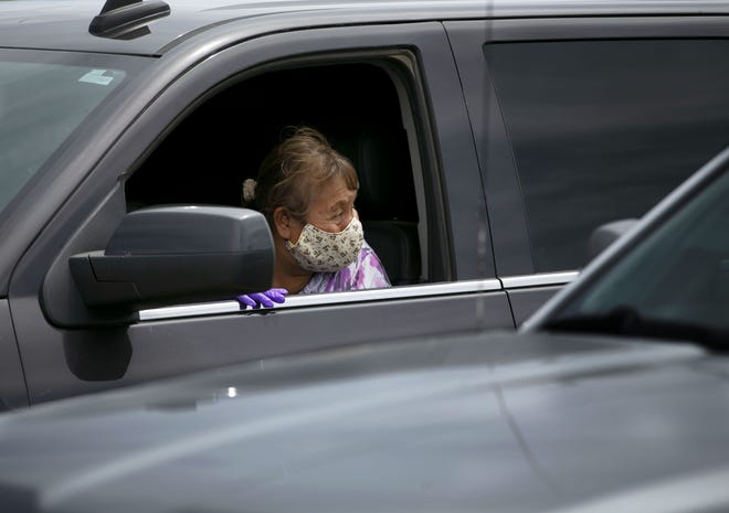 Frances Shirleson waits in her vehicle to receive food at a food distribution point before the start of a weekend-long curfew in Coyote Canyon, New Mexico, on the Navajo Nation on May 15, 2020.