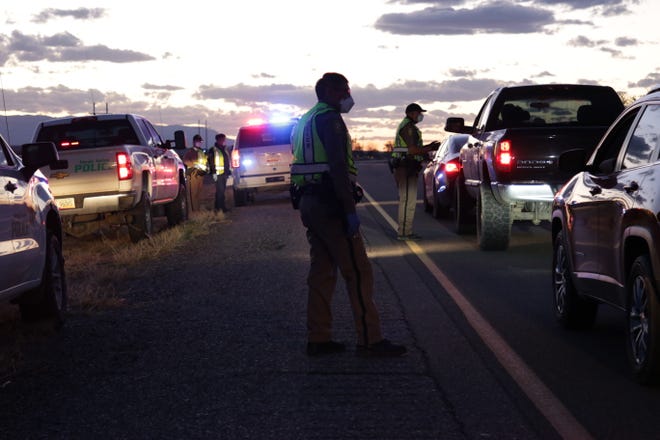 The Navajo Police Department conducts a checkpoint in Hogback on April 1 to share information about the curfew order on the Navajo Nation.